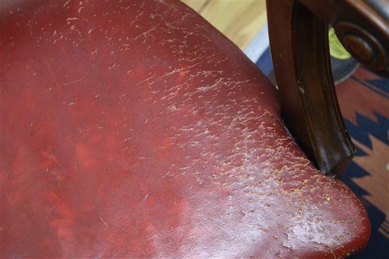 A Victorian red leather elbow chair